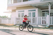 © Marc Tran/Stocksy - Asian boy ride bicycle in summertime with warm sunlight.
