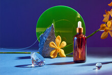 Glass Bottle With Natural Essential Oils On A  Podium With A Orchid Flower.