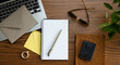 © Lauren Lee/Stocksy - Desk with computer and notebook
