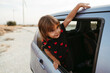 © Irina Polonina/Stocksy - A little girl sitting in a car.