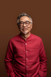 © Santi Nuñez/Stocksy - Happy Asian Man in Studio Shot