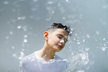 Boy With Splash Of Water On Sunlight