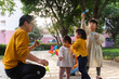© Bo Bo/Stocksy - happy asian kids playing in the sunny park