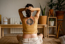 Tattooed Woman Showing The Mandala Tattoo On Her Back 