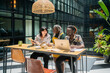 © Luis Velasco/Stocksy - Three Business People Working In A Wide Coworking.