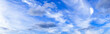 Panoramic summer sky with white clouds on bright blue horizon