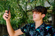 © Erin Brant/Stocksy - Handsome teen taking selfie