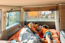 Mother And Son Having Fun In Camper Van