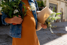 Woman Holding Flower Arrangements At Street