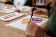 © Javier Pardina/Stocksy - Preparing the drawing for art class with paint
