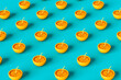 © Giada Canu/Stocksy - pattern of 3D render of an orange with a straw on blue