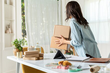 Woman Moves Packages In Home Office