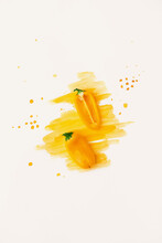Creative Arrangement Of Yellow Bell Peppers On White Background