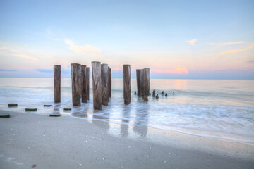 Wall Mural - Sunrise over old pier on the ocean at Port Royal Beach