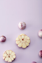 Closeup Design Arrangement Of Garlic, On Lilac Background