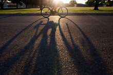 Bike Wheels And Shadow As Sun Sets 