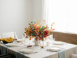 © Marta Locklear/Stocksy - Fall decor table setting with foraged leaves