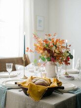 Fall Decor Table Setting With Foraged Leaves And Fresh Bread