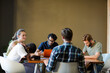 © KOTO - Creative business people working at tables in sunny office