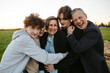 © Rob and Julia Campbell/Stocksy - Fun loving family hugging together outside.