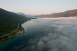 © Adam Sébire/Stocksy - Misty clouds rolling over Norway fjord