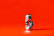 © Heng Yu/Stocksy - A Crushed can with red background
