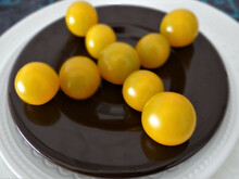 Closeup Of Delicious Cape Gooseberries Put In A Cross Pattern On A Black Plate