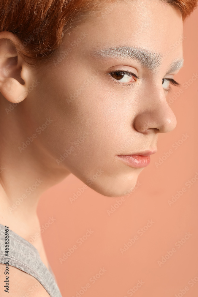 Teenage boy with dyed eyebrows on color background, closeup