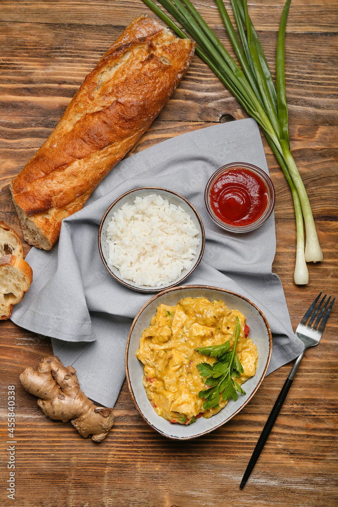 Composition with tasty chicken curry on wooden background