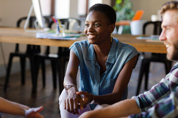 Smiling casual business people talking in office