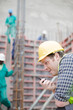 © KOTO - Construction worker with walkie-talkie at construction site