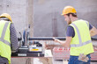 © KOTO - Construction workers adjusting metal bar at construction site