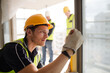 © KOTO - Construction worker measuring window at construction site