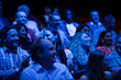 Happy audience in dark room