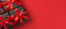 Top View Photo Of Black Gift Boxes With Red Ribbon Bow On Isolated Red Background With Copyspace