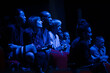 Smiling, enthusiastic audience in dark auditorium