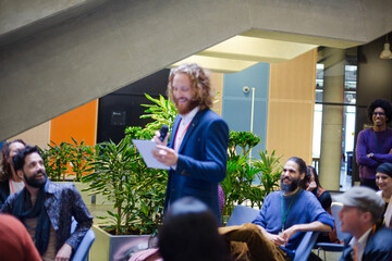 Male speaker on stage talking to audience