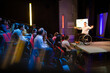© KOTO - Audience watching male speaker in wheelchair talking on stage