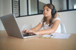 © goodluz - young girl on a laptop computer doing her lessons at home