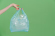 © Drobot Dean - Photo of hand holding bag with plastic waste