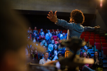 Man filming speaker and audience