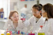 © KOTO - Girl students conducting scientific experiment in laboratory classroom