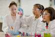 © KOTO - Girl students conducting scientific experiment in laboratory classroom