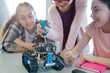 © KOTO - Students playing with robot in classroom