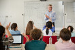 © KOTO - Male teacher leading lesson at whiteboard in classroom