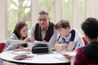 © KOTO - Male teacher and students using laptop at table