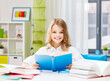 © Syda Productions - education and school concept - happy smiling student girl reading book over home background