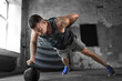 © Syda Productions - sport, bodybuilding, fitness and people concept - young man doing kettlebell push-ups in gym
