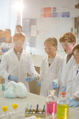 Wall Mural - surprised students conducting scientific experiment, watching chemical reaction in classroom laborat