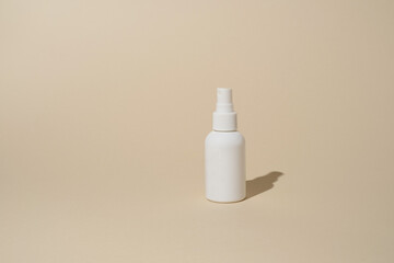 white plastic bottle on beige background